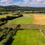 Lush fields and distant rolling hills.