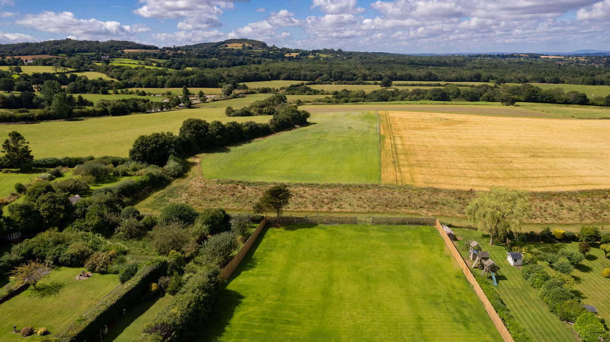 Lush fields and distant hills landscape.