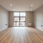 Spacious, empty room with large window.