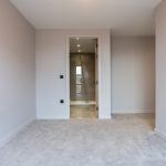 Empty room with grey carpet and doorway