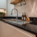 Modern kitchen with sleek black surfaces.