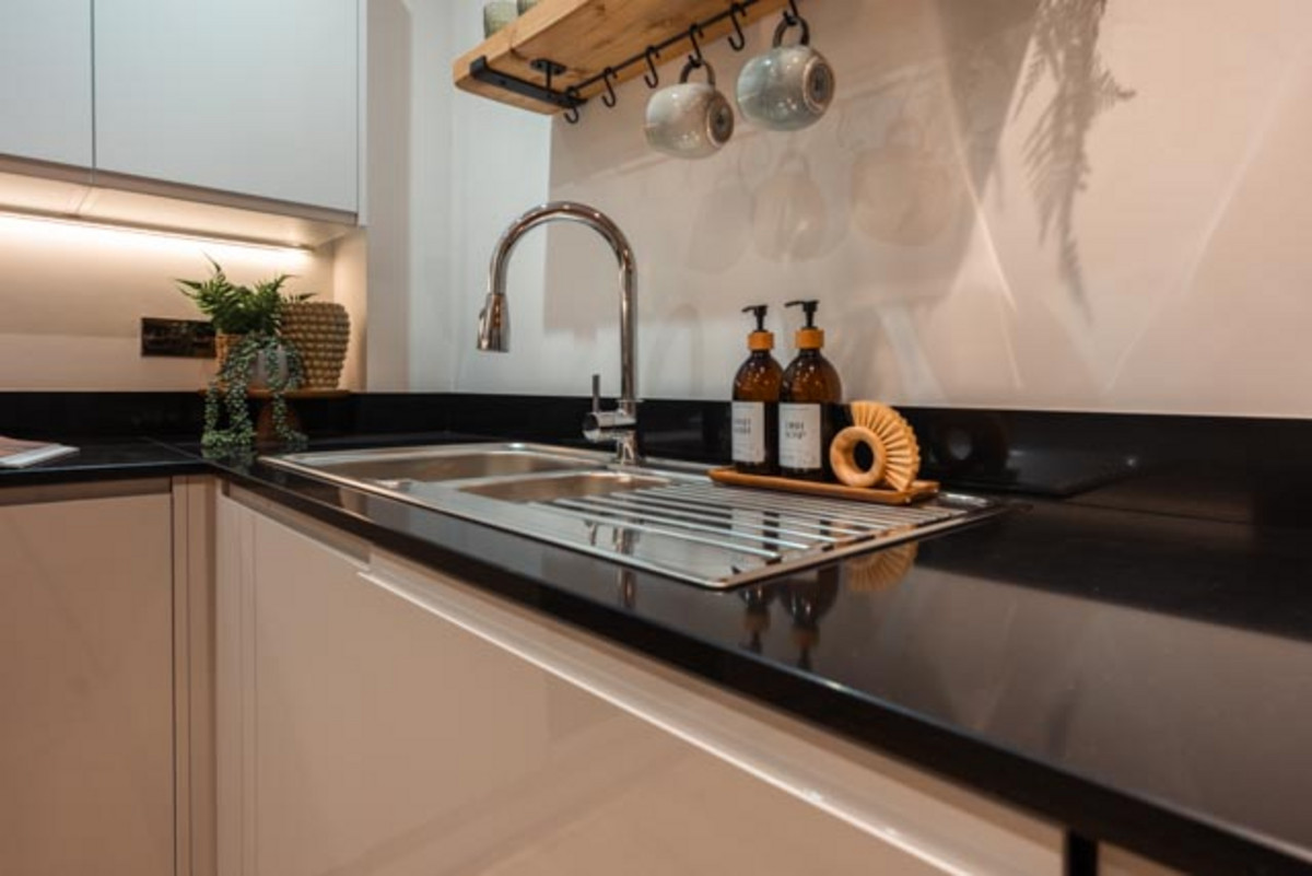 Modern kitchen with sleek black surfaces.