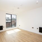 Bright, empty room with large window.