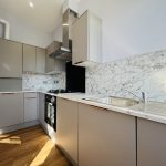 Modern kitchen with marble countertops.