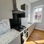 Modern kitchen with marble surfaces.