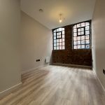 Spacious room with exposed brick walls.