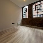 Spacious room with large windows.