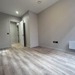 Empty room with wooden flooring.