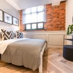 Stylish bedroom with exposed brick wall.