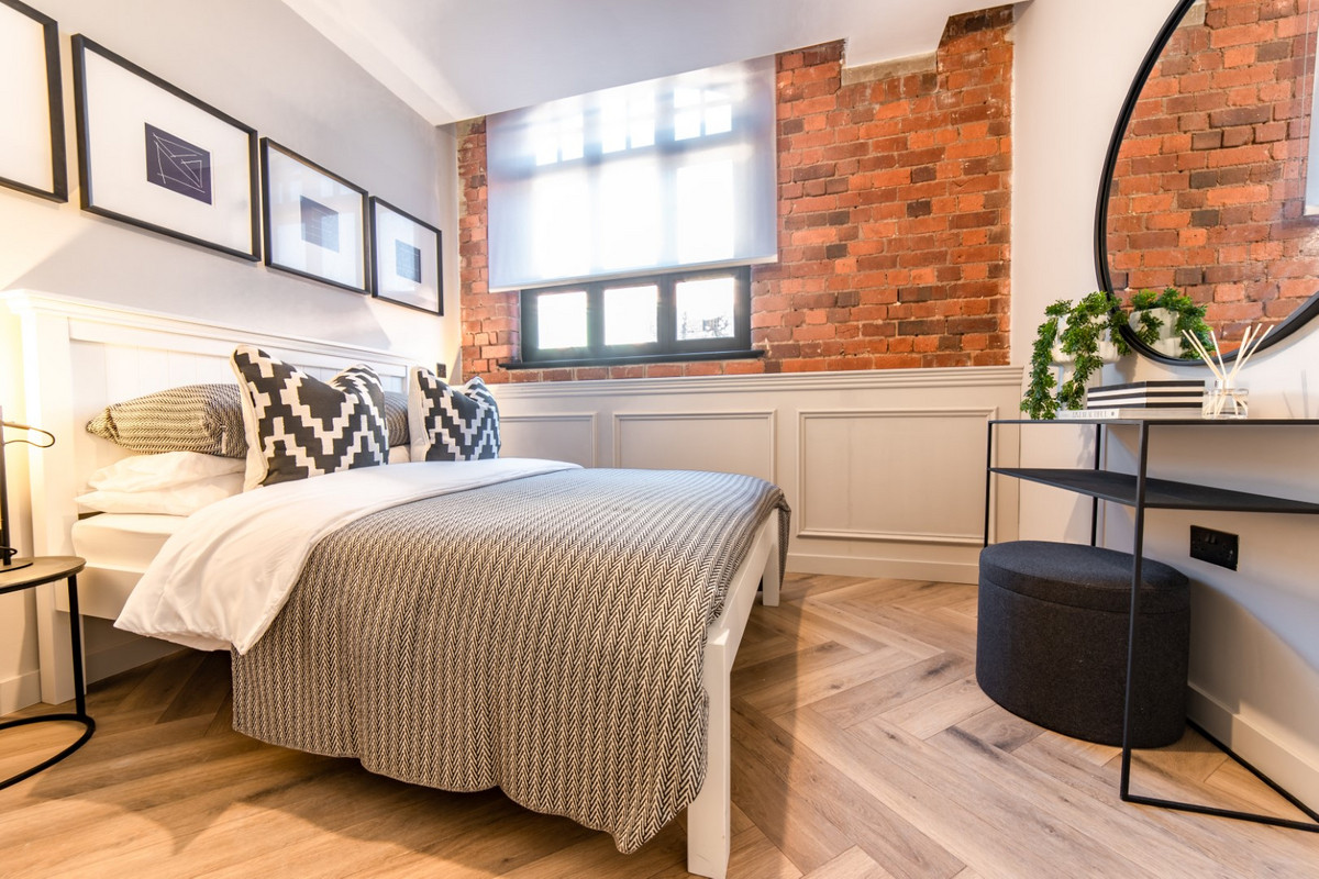 Stylish bedroom with exposed brick wall.