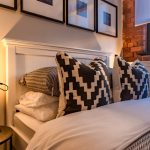 Stylish bedroom with patterned cushions.
