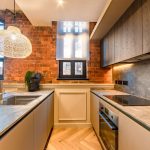Modern kitchen with exposed brick wall