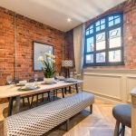 Stylish dining area with exposed brick.