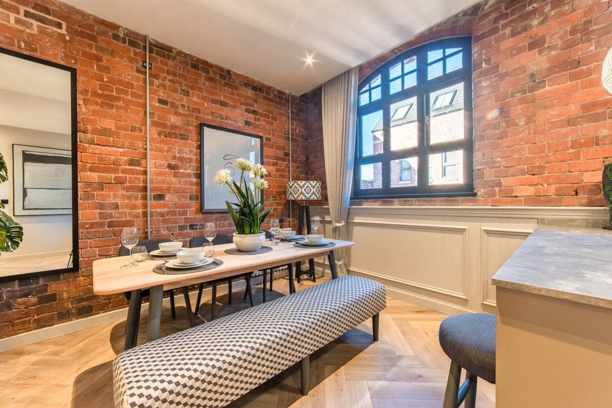 Stylish dining area with exposed brick.