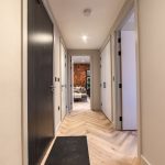 Modern hallway with wooden flooring.