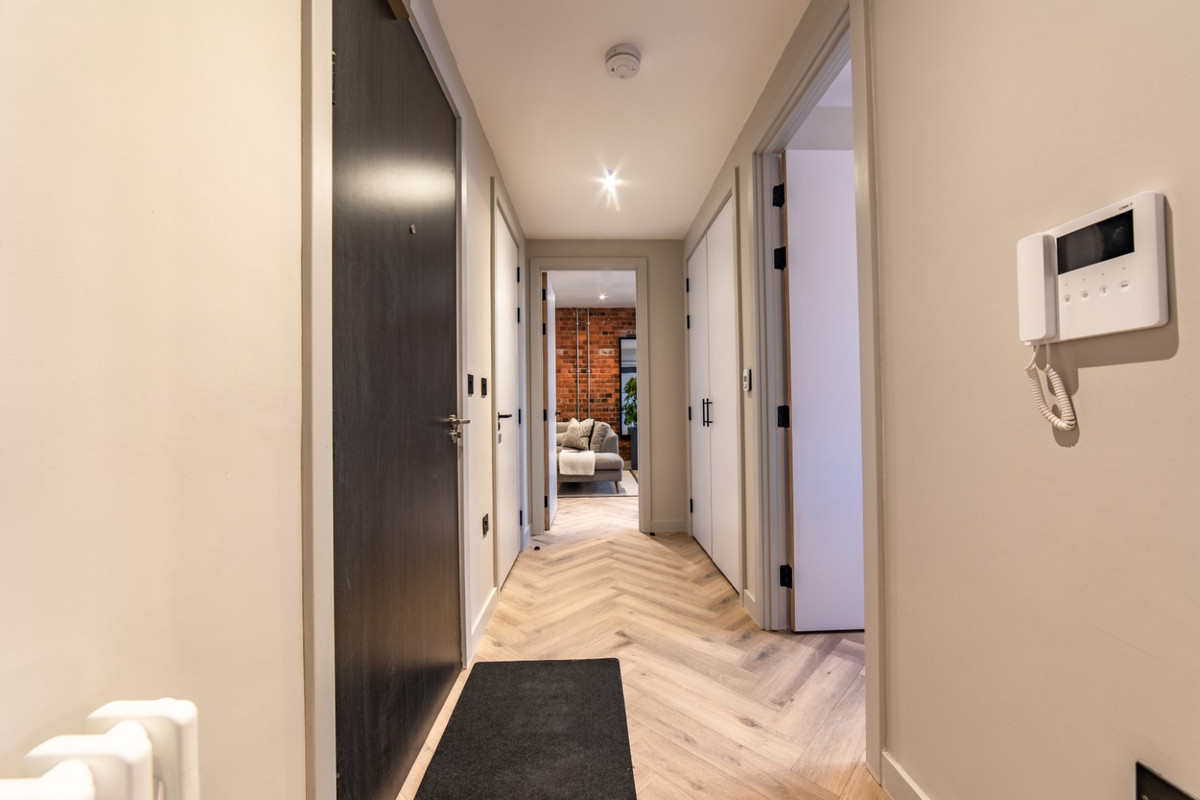 Modern hallway with wooden flooring.