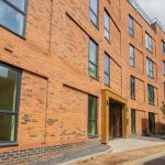 Modern brick building with large windows.