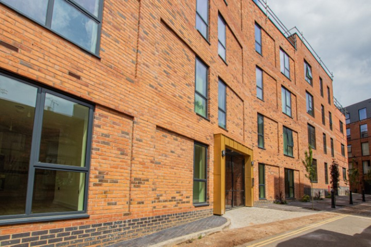 Modern brick building with large windows.