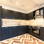 Modern kitchen with dark cabinetry.