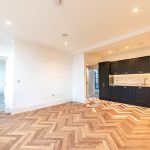 Modern kitchen with herringbone flooring.