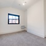 Empty room with grey carpet and window