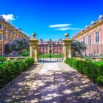 Elegant university courtyard under blue sky.