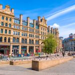 Historic buildings in vibrant city square.