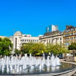 Fountain in vibrant city square.