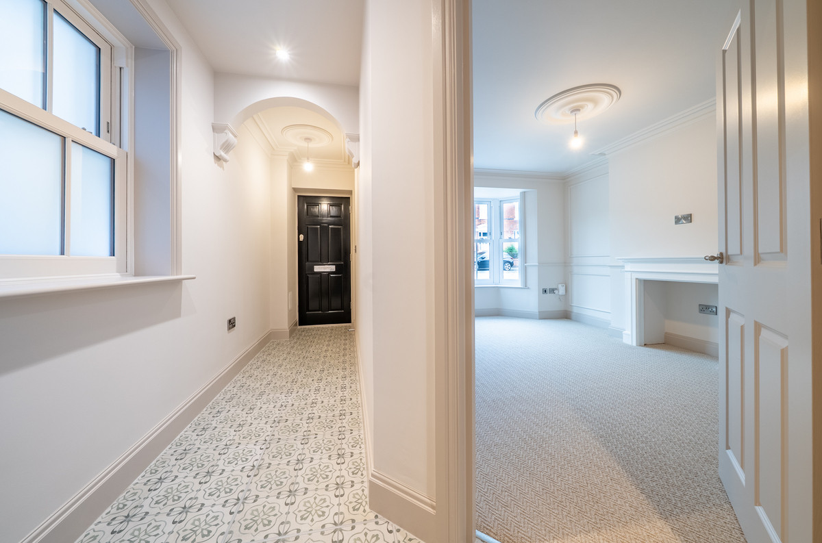 Bright, modern hallway and living area.