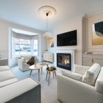 Modern, stylish living room with fireplace.