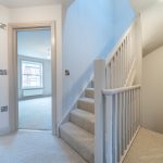Bright, modern hallway with staircase.