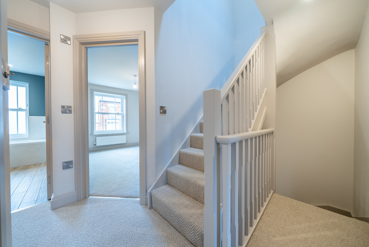 Bright, modern hallway with staircase.