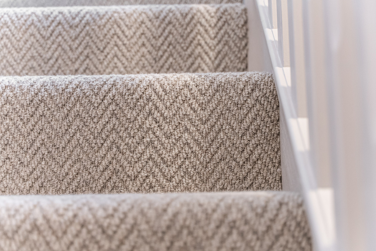 Textured carpeted stairs in natural light.