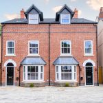 Two identical red-brick semi-detached houses