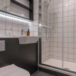 Modern bathroom with shower and sink.