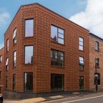 Modern brick building with large windows.