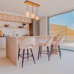 Luxurious kitchen island with bar stools and pendant lights