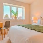 Modern bedroom looking out over garden