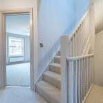 Bright, spacious hallway with stairs.