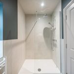 Modern shower with glass enclosure.