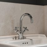 Modern chrome tap on white sink