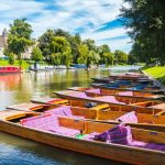 Boats lined along a picturesque river.
