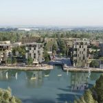 Modern waterfront development with green spaces.