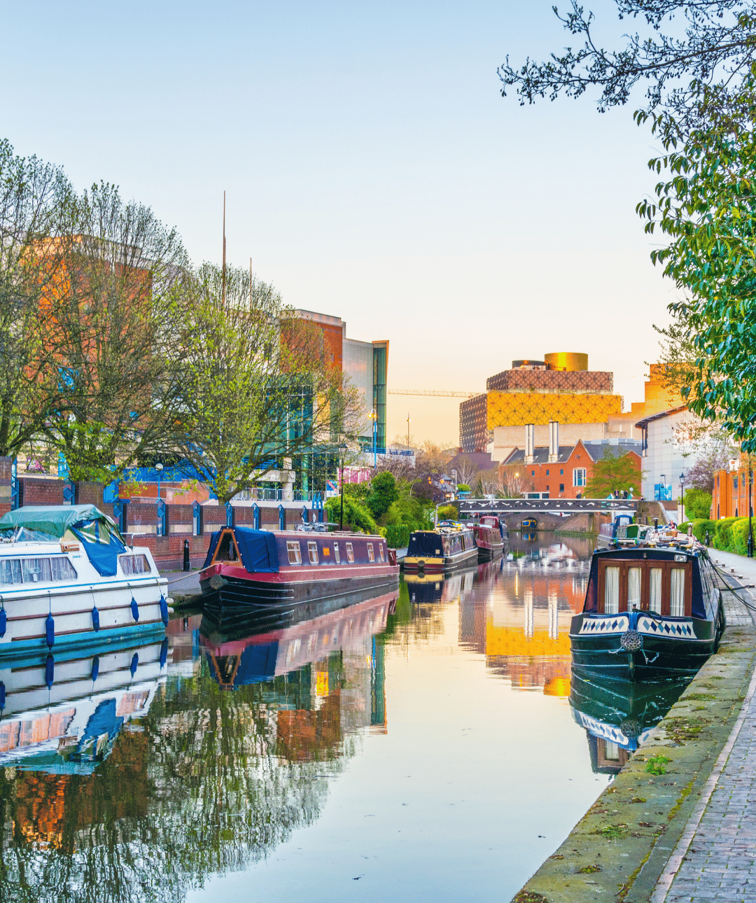Serene canal lined with colourful boats.