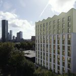 Modern building amidst urban skyline.