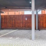 Empty parking space with wooden fence.