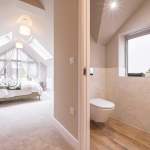 Modern, spacious bedroom with adjoining bathroom at Avon Bard. A bespoke four-bedroom home in Stratford Upon Avon.