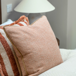 Cosy bedroom with decorative cushions at Avon Bard - bespoke home in Stratford Upon Avon.