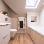 Modern luxury bathroom with skylight flooding natural light at Avon Bard. A bespoke four-bedroom home in Stratford Upon Avon.