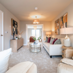 Stylish, modern living room interior design with neutral tones and vibrant accents in artwork and cushions in Stratford Upon Avon.